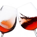 pair of moving wine glasses over a white background, cheers!