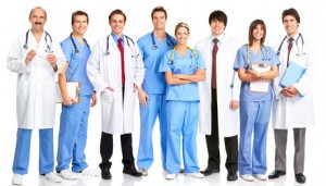 Smiling medical people with stethoscopes. Doctors and nurses over white background