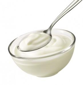 Nice product shot from a bowl and spoon with yoghurt.